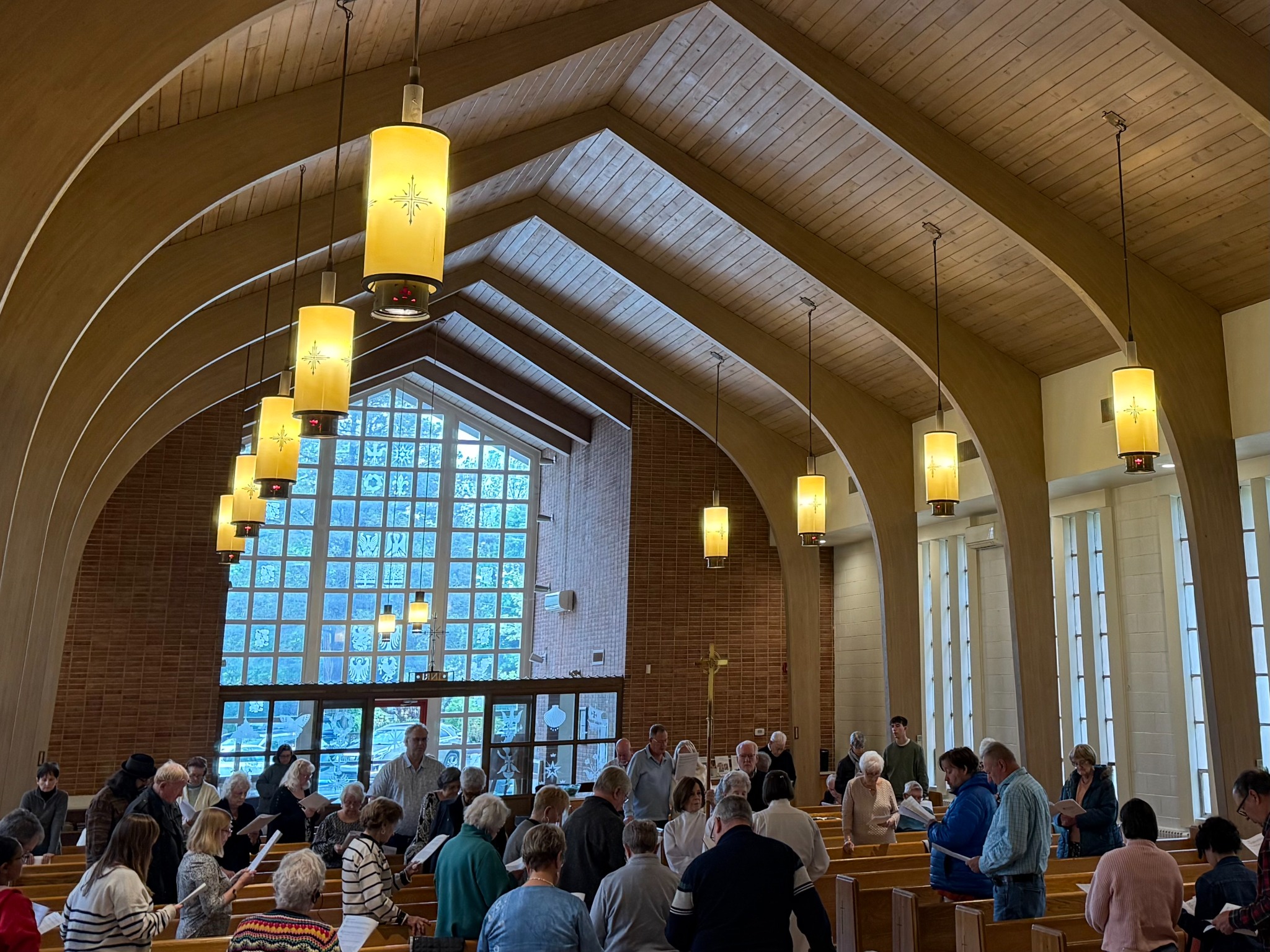 The Holy Trinity congregation gathered for worship beneath the sanctuary's wooden arches